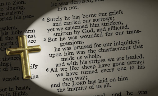 36349145 - the bible passage isaiah 53:4-6, lit up by the cross